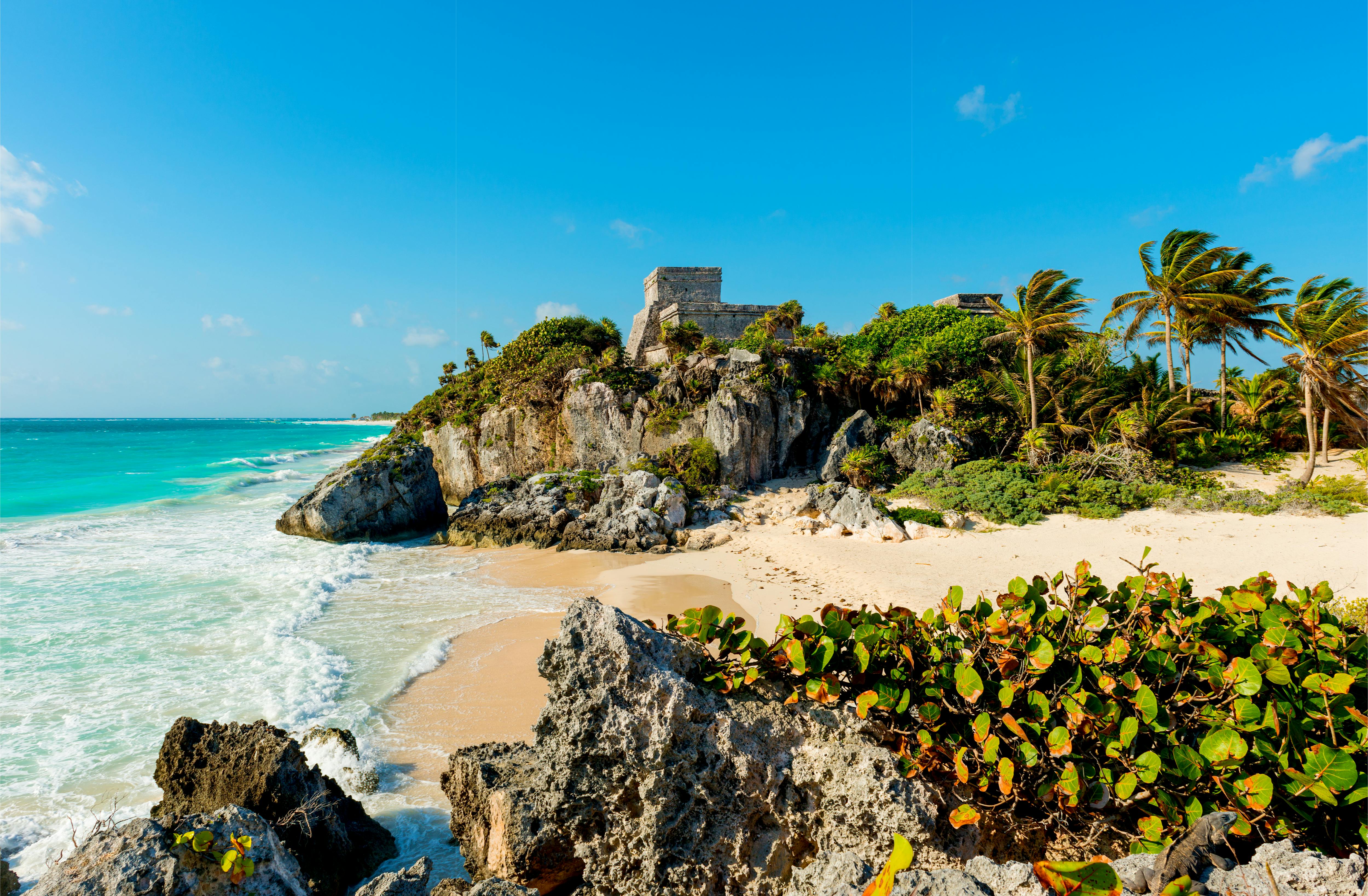 The turquoise waters and white sand beach of the Caribbean Sea is the perfect backdrop for exploring Mexico's Mayas ruins.